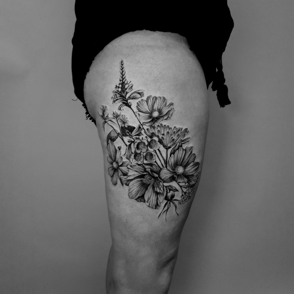 floral wildflower thigh tattoo