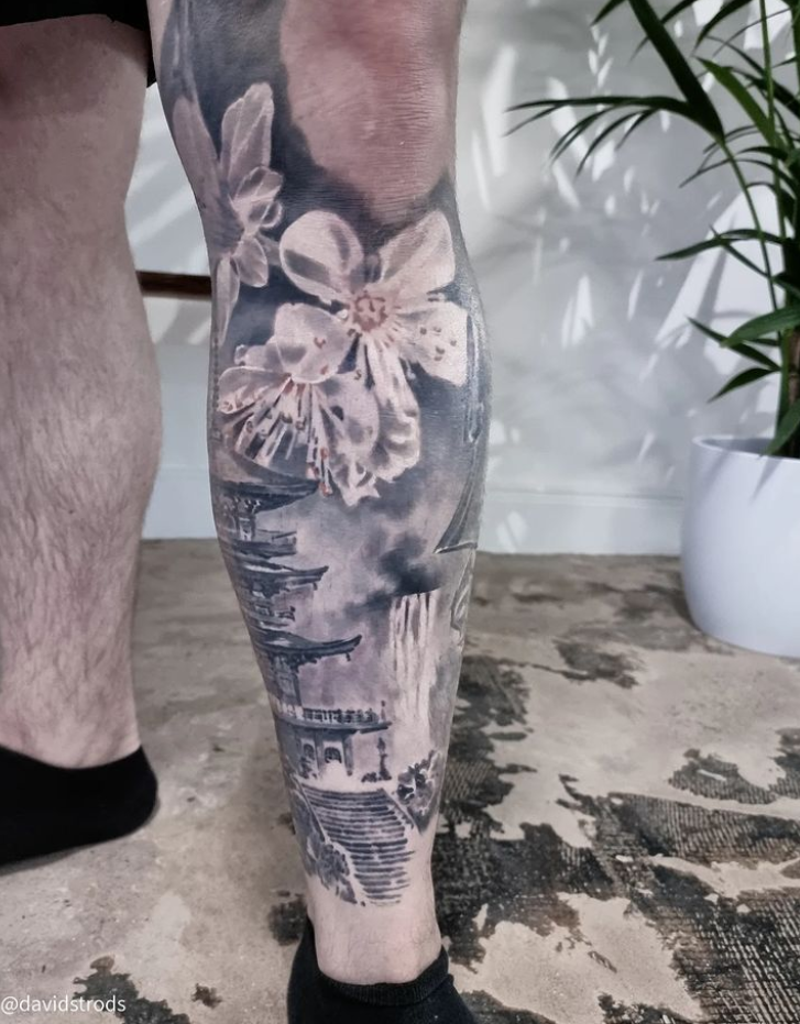 Leg sleeve blossom pagoda tattoo.